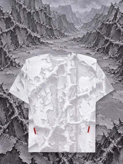 The white Bloodrose White t-shirt in front of mountains of grey paper brambles in relief.