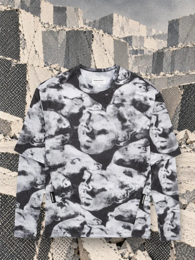 The black and white Camo Black long sleeve t-shirt in a quarry of white and grey paper blocks.