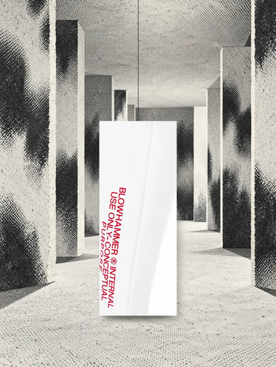 A piece of the leg of the white Concept joggers, with the printed red lettering, hanging on a thread among pillars of grey halftone paper.
