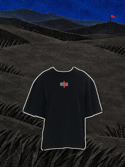 The black Flag t-shirt with the red label on the chest, above black paper hills under a blue night sky.