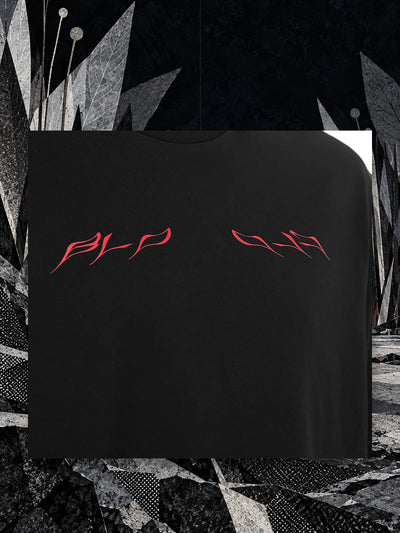 A piece of the chest of the black Insectide t-shirt, with the red lettering, hanging on a thread among paper blades in the night.