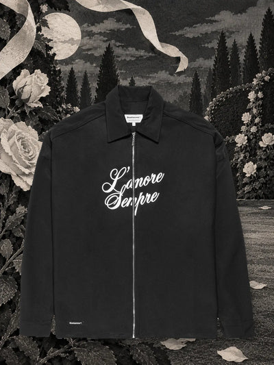The black L'amore sempre zip shirt jacket in a night garden of black paper, among roses and ribbons of white paper.