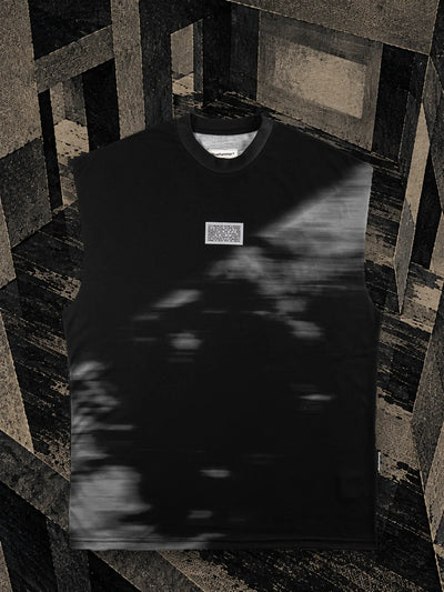 The black Leak tank top in a room of dark paper, with black ink dripping down the walls and onto the floor.