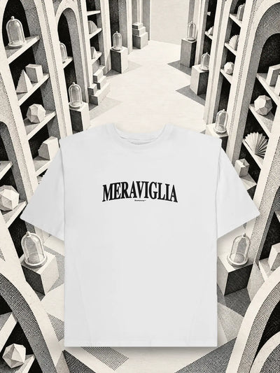 The white Meraviglia t-shirt among arches and shelves of white and black paper seen from above.