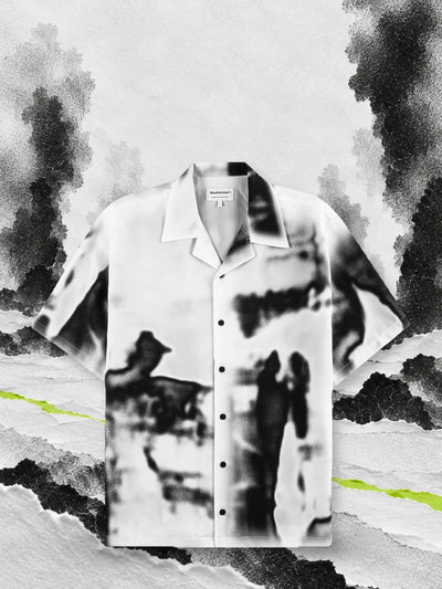 The white and black Rift short sleeve shirt on paper snow, among columns of black smoke.