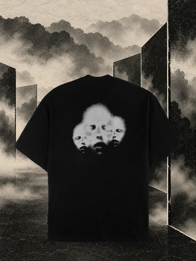 The black Triodrome t-shirt among dark paper panels and sand coloured fog.